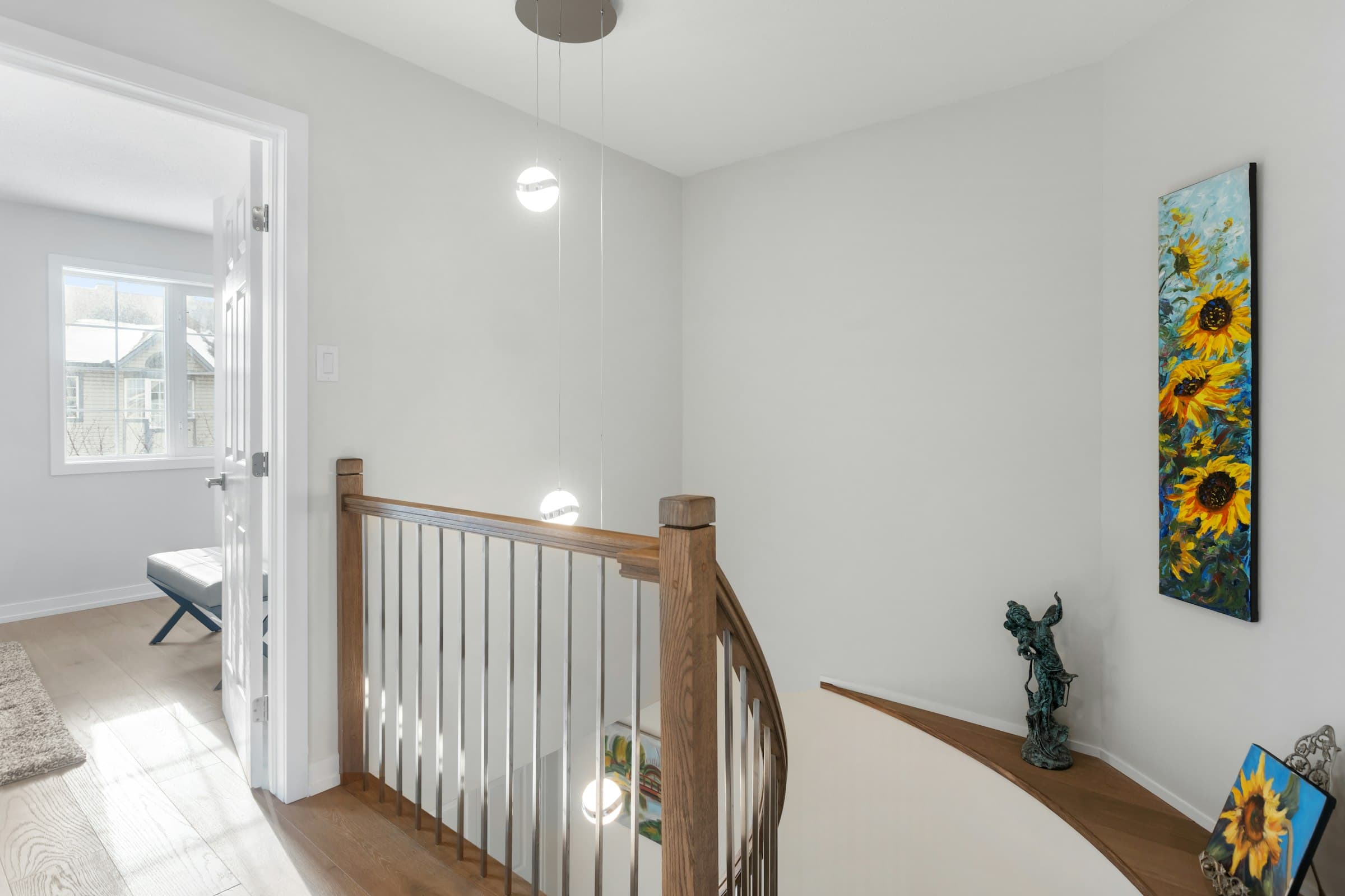 A bright, freshly painted hallway with crisp white trim and staircase