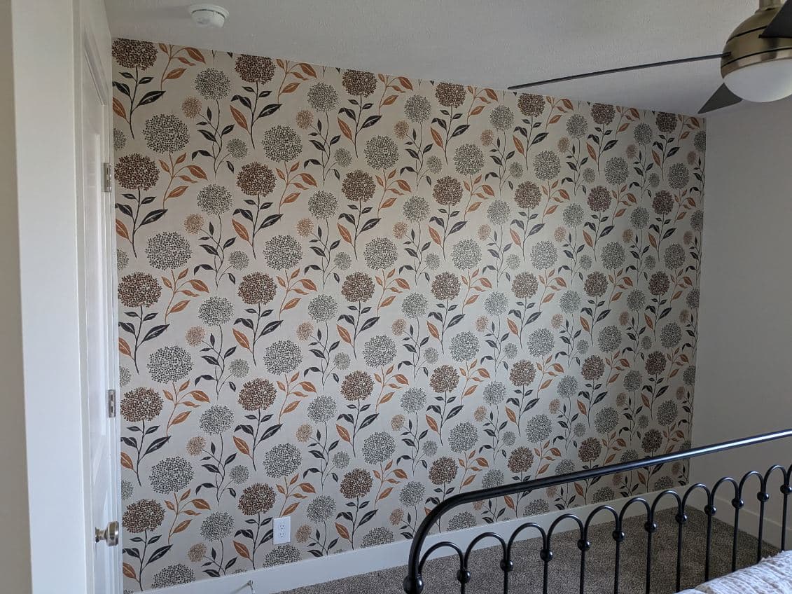 Hydrangea patterned wallpaper on a bedroom accent wall