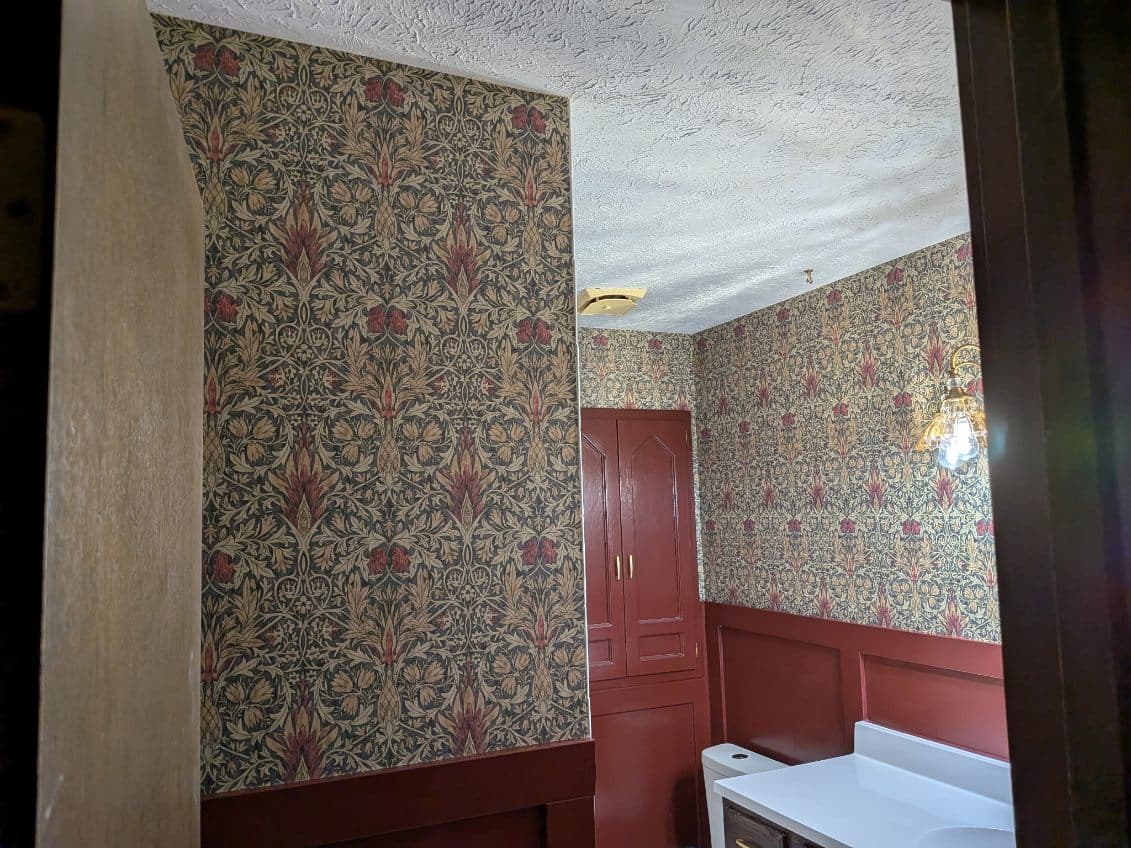 Deep jewel-toned designer wallcovering wrapping a room corner